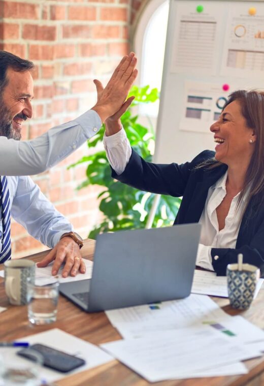 Man and Woman high fiving after finding out How to fill a senior position quickly