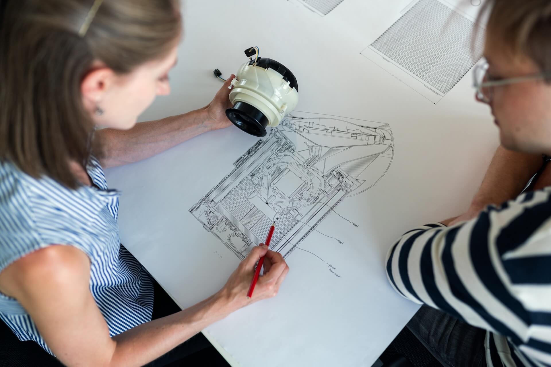 Two women who work in aerospace drawing a sketch